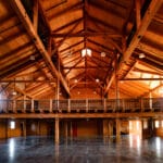 elegant open rafter event center with amish crafted wooden features view of balcony