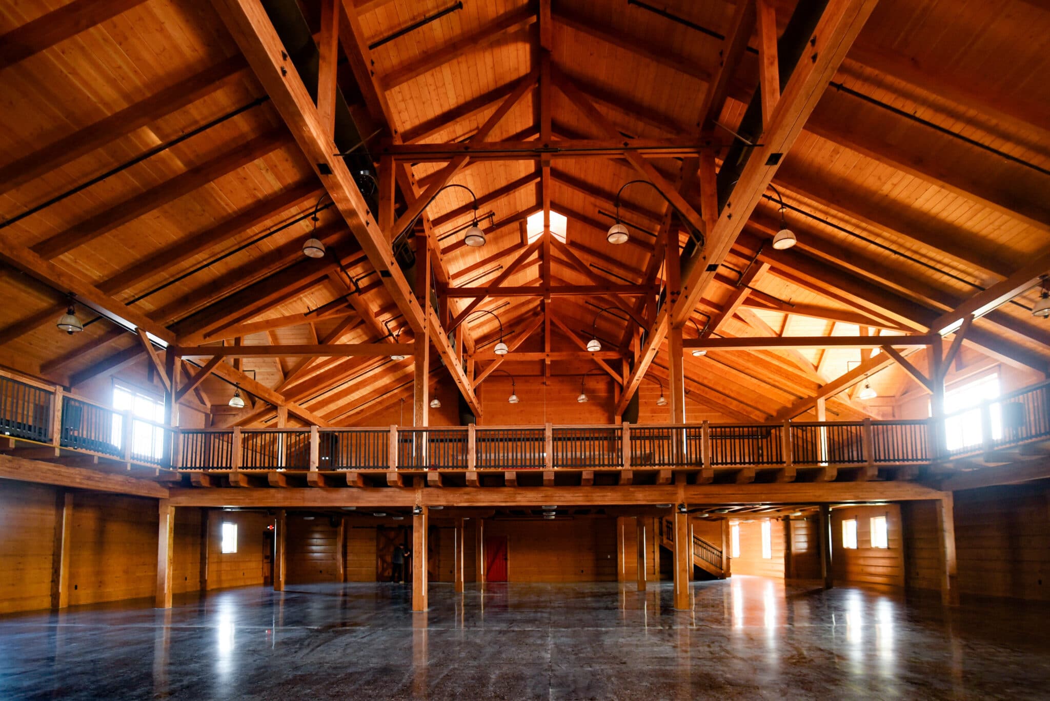 elegant open rafter event center with amish crafted wooden features view of balcony