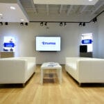 minimalist lobby with white couches and coffee table at Truma Corporation