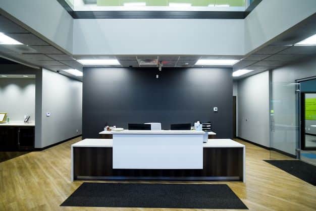 modern, minimalist lobby with wood floors at Genesis Products headquarters in Goshen Indiana