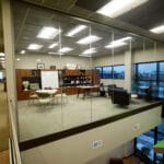 spacious glass-walled second floor office at Genesis Products