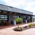 beautiful sunlit office patio with benches and landscaping