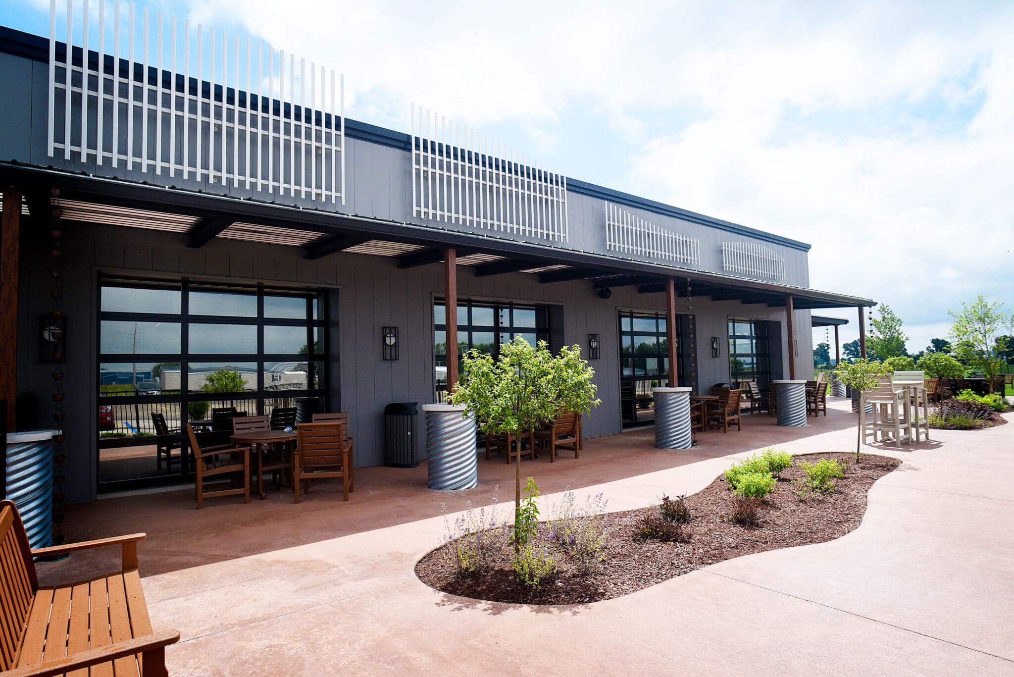 beautiful sunlit office patio with benches and landscaping