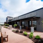 beautiful sunlit office patio with benches and landscaping