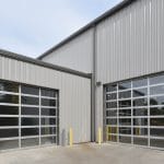 exterior shot of glass and metal garage doors on warehouse for Duo Form in Edwardsburg Michigan