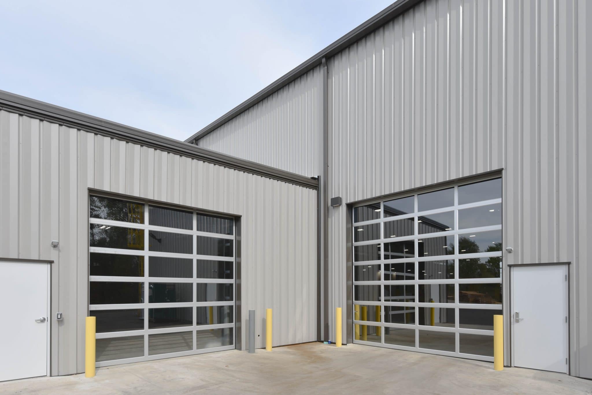 exterior shot of glass and metal garage doors on warehouse for Duo Form in Edwardsburg Michigan