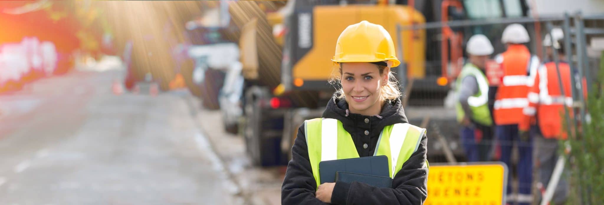 panoramic view of young female architect with construction team in background