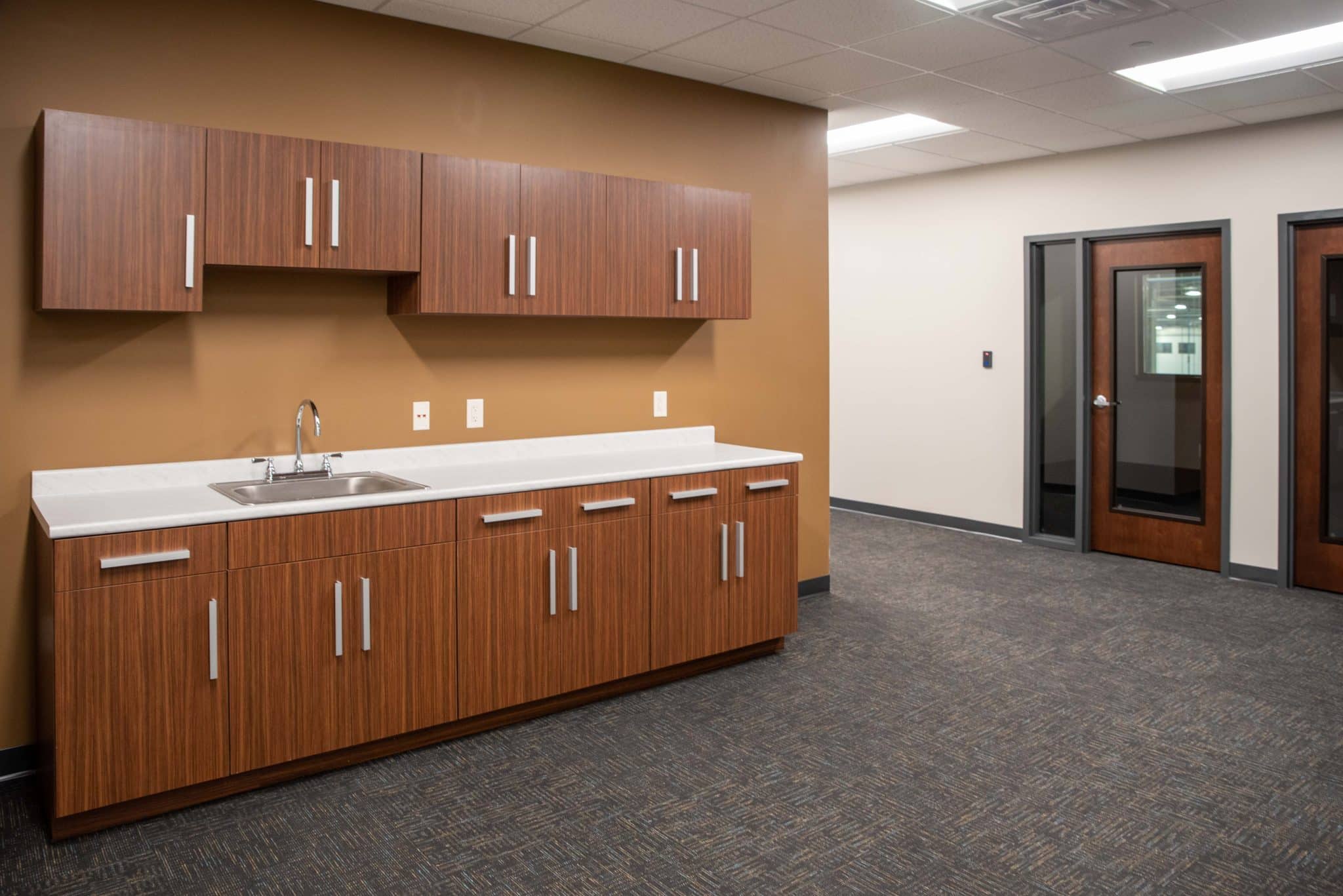 small kitchenette in hallway opening outside offices