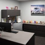clean windowless office with portrait of Whiteford Kenworth semitruck on wall