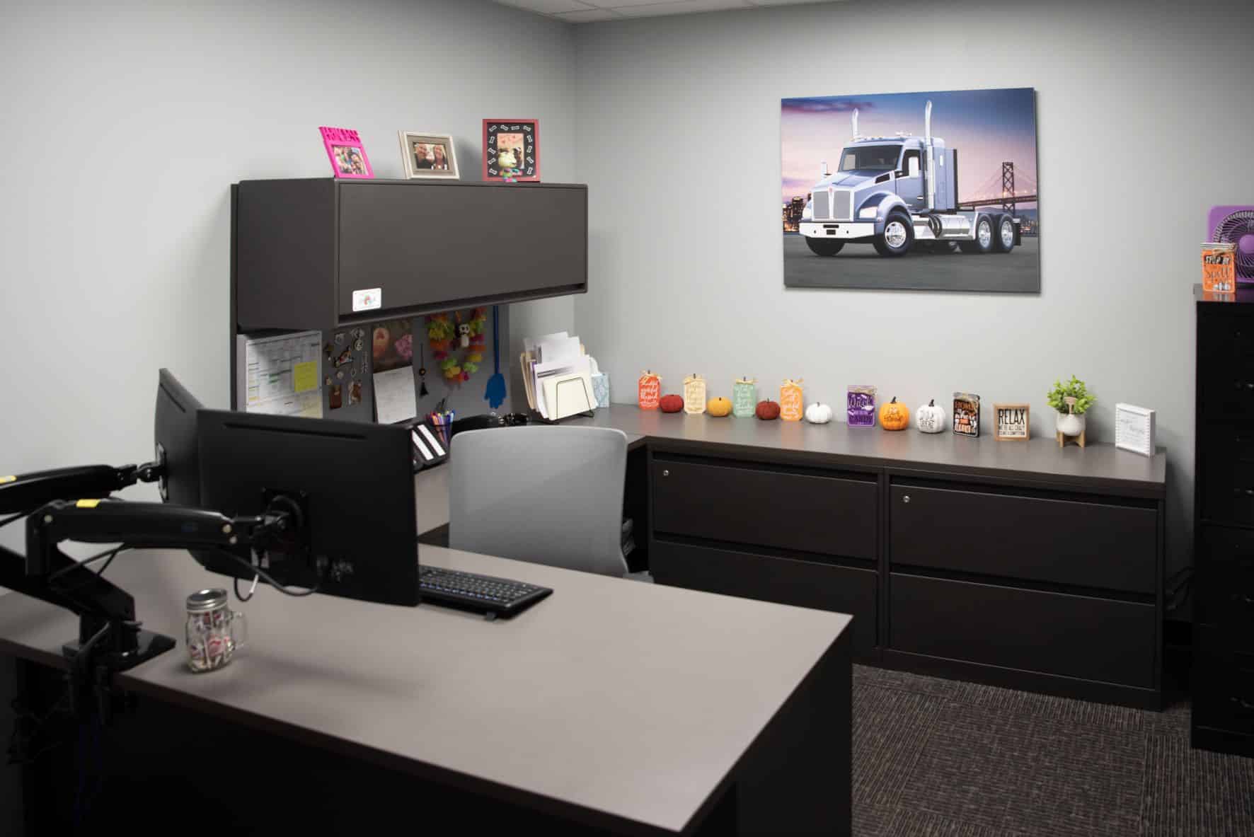 clean windowless office with portrait of Whiteford Kenworth semitruck on wall