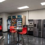 employee break room with fridges, high top tables and chairs, and vending machines