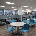 employee breakroom with vending machines, tables and chairs, and booth seating