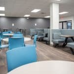 employee break room with tables and chairs and booth seating