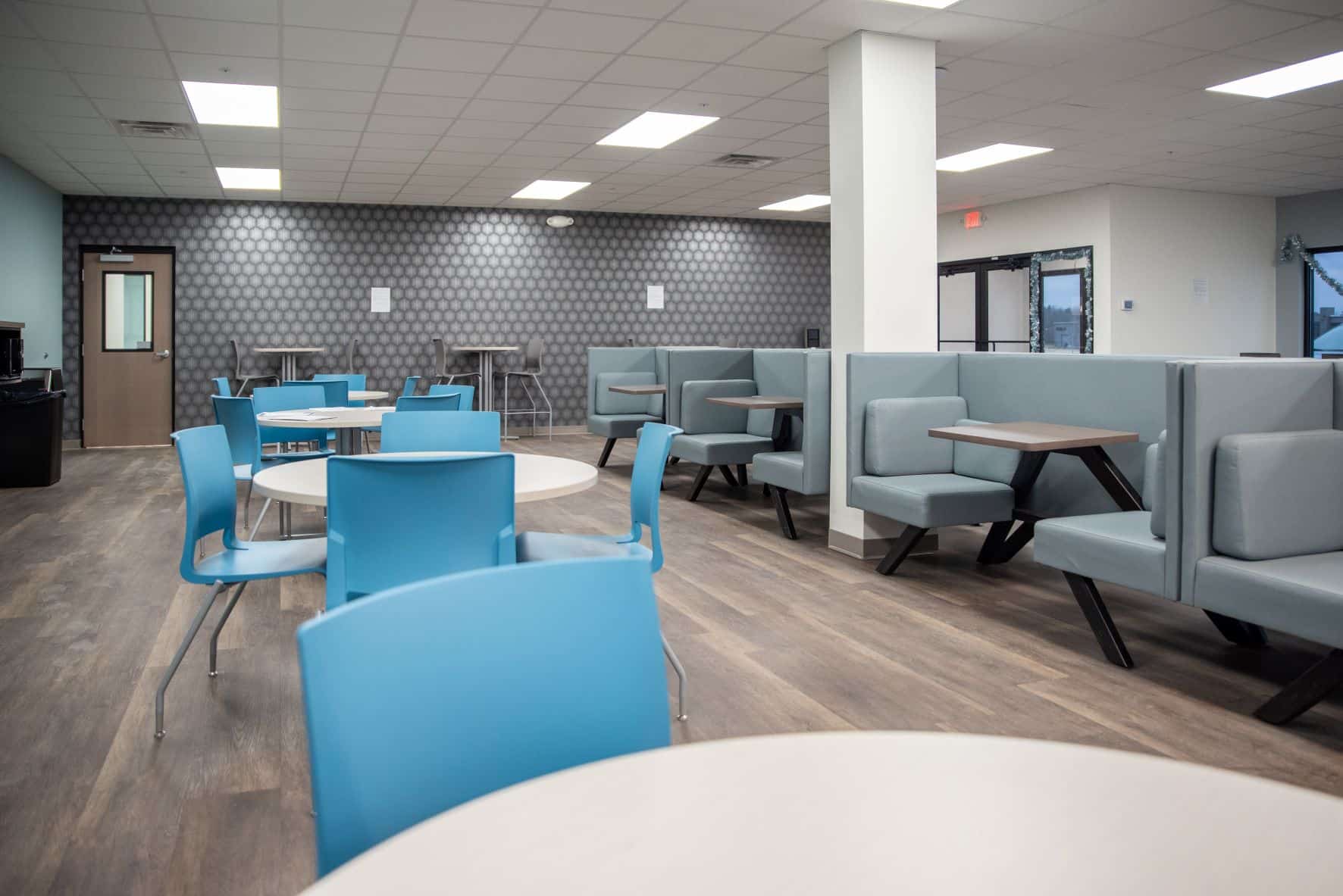 employee break room with tables and chairs and booth seating