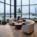 office lobby with tall glass walls and curved sectional couches