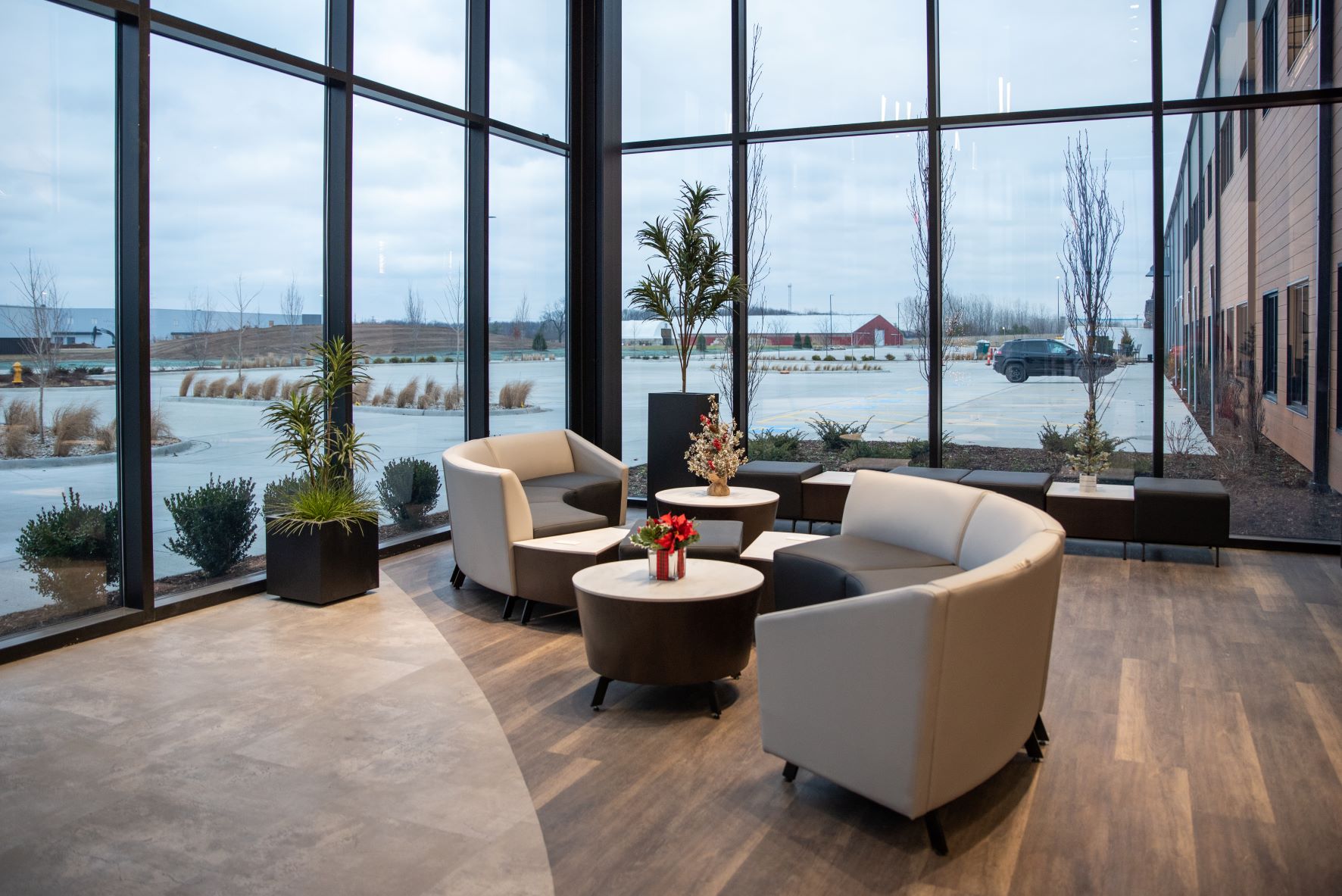 office lobby with tall glass walls and curved sectional couches