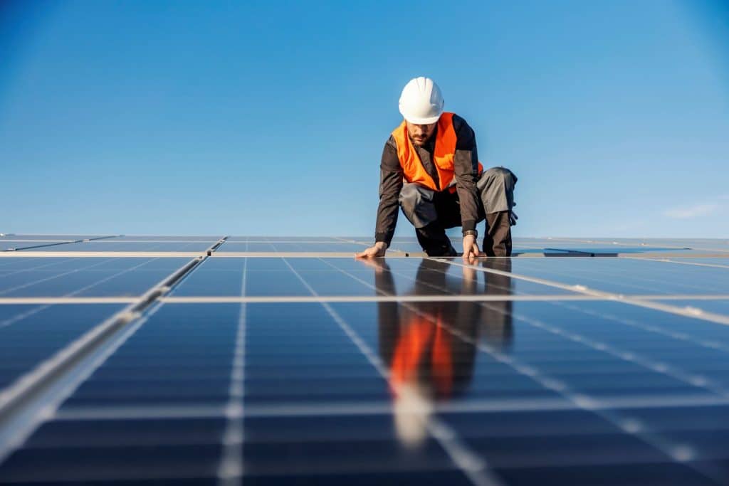 laborer installing integrated solar roof like nucor powershingle