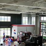 Interior of Whiteford Kenworth Toledo showroom with large windows, trucks on display, and 50th anniversary decorations.