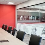 Conference room at Whiteford Kenworth Toledo with long meeting table, black chairs, and red accent wall.