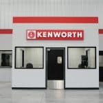 Kenworth service counter inside Whiteford Kenworth Toledo with bold red Kenworth sign and office windows.