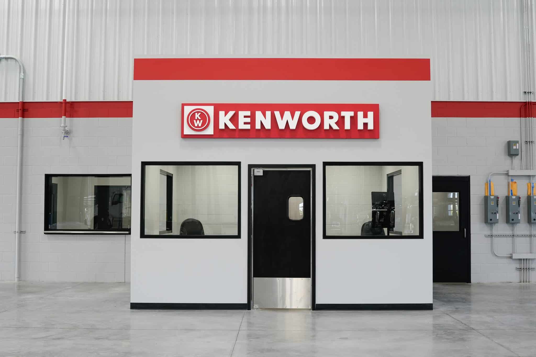 Kenworth service counter inside Whiteford Kenworth Toledo with bold red Kenworth sign and office windows.